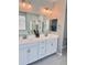 Bright bathroom with double sink vanity, large mirror, and modern fixtures at 11074 W Tonto St, Avondale, AZ 85323