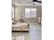 Comfortable bedroom features a full bed, a ceiling fan, and natural light at 11074 W Tonto St, Avondale, AZ 85323