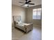 Cozy bedroom with a ceiling fan, window with blinds, and wood-accented bed frame at 11074 W Tonto St, Avondale, AZ 85323