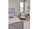 Comfortable bedroom features a full bed, a ceiling fan, and natural light at 11074 W Tonto St, Avondale, AZ 85323