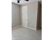 Clean bedroom showcasing tile floors, neutral paint, and a white door and baseboards at 11074 W Tonto St, Avondale, AZ 85323
