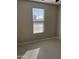Well-lit bedroom features tile floors and a window that allows natural light to fill the room at 11074 W Tonto St, Avondale, AZ 85323