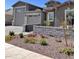 Beautifully landscaped front yard with stone accents and a paved driveway offers great curb appeal at 11074 W Tonto St, Avondale, AZ 85323