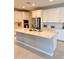 Bright, open kitchen features a large center island and white cabinets for a clean, modern look at 11074 W Tonto St, Avondale, AZ 85323