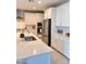 Modern kitchen features stainless steel appliances, white cabinets, and a subway tile backsplash at 11074 W Tonto St, Avondale, AZ 85323