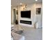 Cozy living room with a modern fireplace, large TV, and stylish decor at 11074 W Tonto St, Avondale, AZ 85323