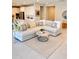 Open living room with neutral furnishings, a jute rug, and access to the kitchen offer a cozy, inviting space at 11074 W Tonto St, Avondale, AZ 85323