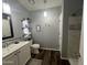 Well-lit bathroom with a vanity, decorative shelves, and a shower with elegant tile accents at 11596 W Sierra Dawn Blvd # 33, Surprise, AZ 85378