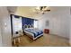 Spacious bedroom with a blue accent wall, vaulted ceiling, carpeted floor, and a bright window at 11596 W Sierra Dawn Blvd # 33, Surprise, AZ 85378