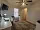Functional bedroom with a built-in desk, ceiling fan, and stylish rug, offering a comfortable workspace at 11596 W Sierra Dawn Blvd # 33, Surprise, AZ 85378