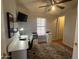 Functional bedroom with a built-in desk, ceiling fan, and stylish rug, offering a comfortable workspace at 11596 W Sierra Dawn Blvd # 33, Surprise, AZ 85378