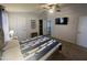 Bright bedroom featuring a comfortable bed, ceiling fan, and access to a closet and bathroom at 11596 W Sierra Dawn Blvd # 33, Surprise, AZ 85378