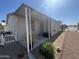 Charming home exterior featuring a cozy covered porch and well-maintained landscaping at 11596 W Sierra Dawn Blvd # 33, Surprise, AZ 85378