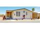 Exterior of home featuring desert-themed decor, gravel landscaping, and an enclosed porch at 11596 W Sierra Dawn Blvd # 33, Surprise, AZ 85378