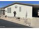 Charming home featuring desert landscaping and covered parking, complemented by a clear blue sky backdrop at 11596 W Sierra Dawn Blvd # 33, Surprise, AZ 85378