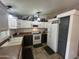 Traditional-style kitchen with white cabinets and modern appliances, view toward kitchen door at 11596 W Sierra Dawn Blvd # 33, Surprise, AZ 85378