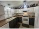 Charming kitchen featuring white and gray cabinets, modern appliances, and appealing decorative touches above the cabinets at 11596 W Sierra Dawn Blvd # 33, Surprise, AZ 85378