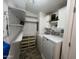 Functional laundry room with washer, dryer, shelving, and storage at 11596 W Sierra Dawn Blvd # 33, Surprise, AZ 85378