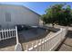 Private back patio area surrounded by white picket fence and shade tree at 11596 W Sierra Dawn Blvd # 33, Surprise, AZ 85378