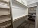 Large walk-in closet with wood racks, shelving, and ample space for organization at 11596 W Sierra Dawn Blvd # 33, Surprise, AZ 85378