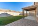 An expansive backyard features manicured turf and a covered patio area for outdoor living at 11644 W Redfield Rd, El Mirage, AZ 85335