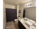 Bright bathroom features tile floors, double sinks, and a shower-tub combination at 11644 W Redfield Rd, El Mirage, AZ 85335