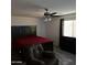Cozy bedroom featuring a ceiling fan, blinds and a comfy chair with a dark wood furniture set at 11644 W Redfield Rd, El Mirage, AZ 85335