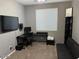 Home office features a large window, built-in shelving, and a dark colored sofa at 11644 W Redfield Rd, El Mirage, AZ 85335