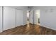 A neutral bedroom features wood-look floors, sliding closet doors, and an ensuite bathroom at 11666 N 28Th Dr # 295, Phoenix, AZ 85029