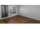A comfortable bedroom includes wood-style floors, natural light, and access to the outdoors at 11666 N 28Th Dr # 295, Phoenix, AZ 85029