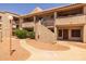 Charming condo complex featuring a terracotta tile roof and desert landscaping at 11666 N 28Th Dr # 295, Phoenix, AZ 85029