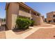Exterior shot showing the complex's well maintained stucco walls and desert landscaping at 11666 N 28Th Dr # 295, Phoenix, AZ 85029