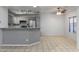 An open kitchen features granite countertops and stainless steel appliances in a well-lit room with tile flooring at 11666 N 28Th Dr # 295, Phoenix, AZ 85029