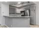 Modern kitchen with gray cabinetry, granite countertops, and stainless steel appliances at 11666 N 28Th Dr # 295, Phoenix, AZ 85029