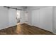 The primary bedroom boasts wood floors, sliding closet doors, and access to the primary bathroom at 11666 N 28Th Dr # 295, Phoenix, AZ 85029