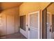 Enclosed patio with a security screen door and neutral colored stucco walls at 11666 N 28Th Dr # 295, Phoenix, AZ 85029