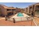 A shared community pool is surrounded by a fence with nearby apartment buildings at 11666 N 28Th Dr # 295, Phoenix, AZ 85029