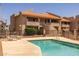 Well-kept, fenced pool is located next to condo buildings with balconies and outdoor seating at 11666 N 28Th Dr # 295, Phoenix, AZ 85029
