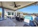 Expansive backyard featuring an outdoor kitchen, seating areas, covered patio and a swimming pool at 11807 W Parkway Ln, Avondale, AZ 85323
