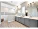 Spacious bathroom featuring a walk-in shower, dual sinks, and modern fixtures at 11807 W Parkway Ln, Avondale, AZ 85323