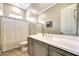 Bathroom with gray vanity cabinets, white countertops and shower-tub combo at 11807 W Parkway Ln, Avondale, AZ 85323