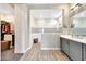 Beautiful bathroom with tiled shower, wood-look flooring, and gray vanity at 11807 W Parkway Ln, Avondale, AZ 85323