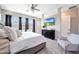 Bright bedroom with large windows, a ceiling fan, and a television at 11807 W Parkway Ln, Avondale, AZ 85323