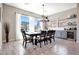 Bright dining room with large windows, stylish lighting, and a bar area at 11807 W Parkway Ln, Avondale, AZ 85323