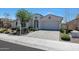 Charming single-story home with a well-manicured front yard and a brick-paved driveway at 11807 W Parkway Ln, Avondale, AZ 85323