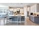 Spacious kitchen with a large center island, stainless steel appliances, and white cabinets at 11807 W Parkway Ln, Avondale, AZ 85323