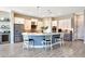 Stylish kitchen featuring a center island with seating, stainless steel appliances, and pendant lights at 11807 W Parkway Ln, Avondale, AZ 85323
