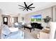 Spacious living room features a modern ceiling fan and neutral color palette at 11807 W Parkway Ln, Avondale, AZ 85323