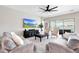 Comfortable living room with modern ceiling fan and views of outdoor patio at 11807 W Parkway Ln, Avondale, AZ 85323