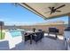Well-appointed outdoor kitchen and dining area with covered patio and a swimming pool at 11807 W Parkway Ln, Avondale, AZ 85323